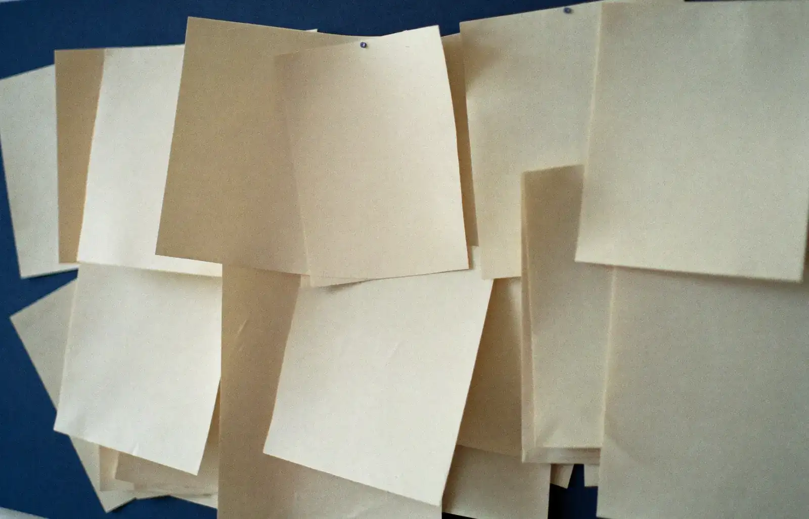 A notice board layered with pinned paper notices