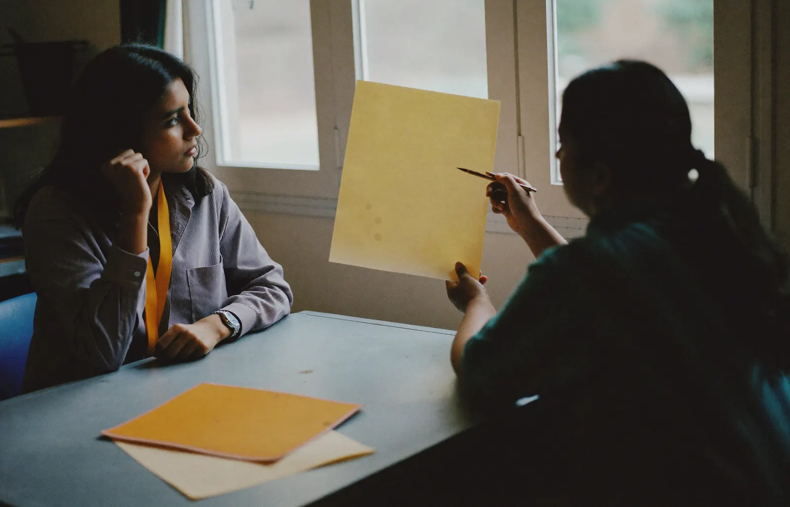 Two colleagues reviewing a form together at a desk
