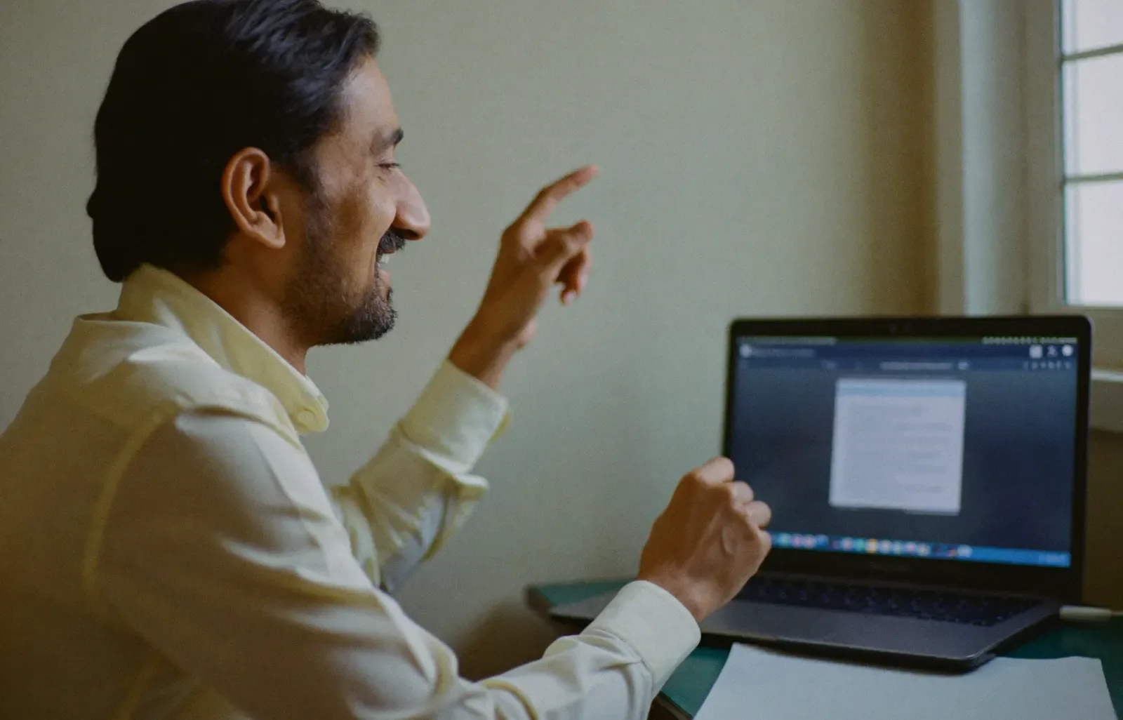 A teacher explaining a topic to a laptop camera