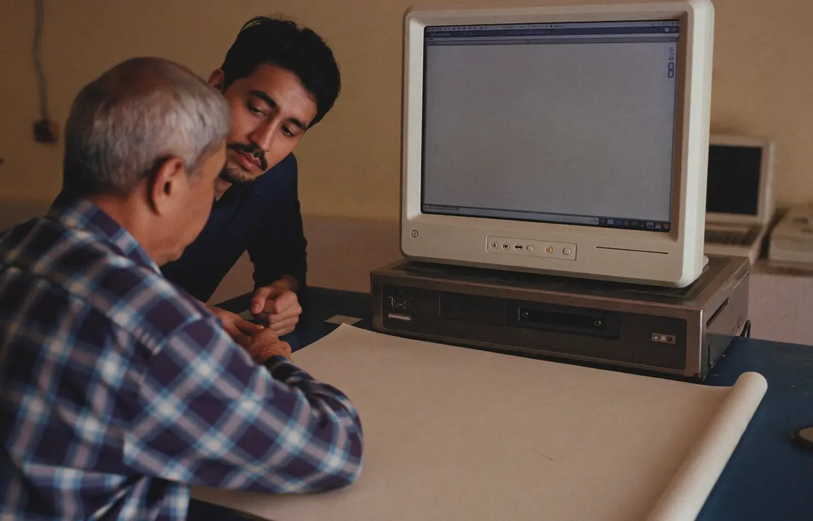 A shopkeeper helping a customer with paperwork at a counter